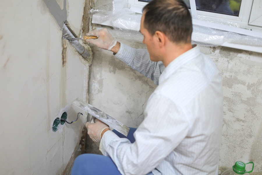 adult man repairing a wall in home setting 2026 03 17 05 59 09 utc